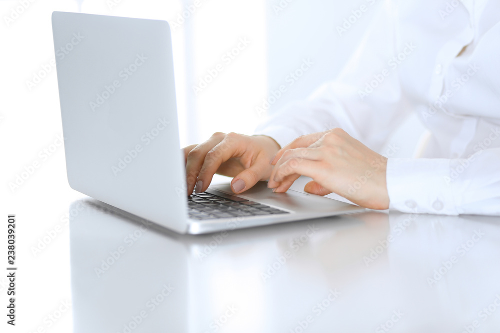 Close-up of business woman hands typing on laptop computer. Secretary at work in office Close-up of business woman hands typing on laptop computer. Secretary at work in office