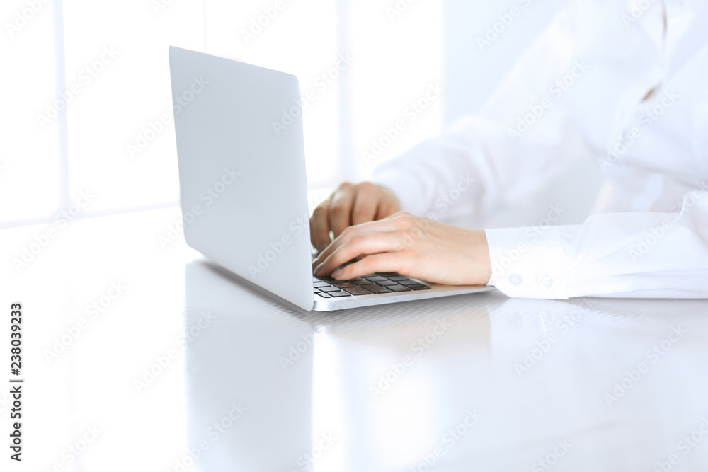Close-up of business woman hands typing on laptop computer. Secretary at work in office Close-up of business woman hands typing on laptop computer. Secretary at work in office