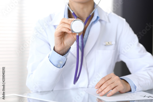 Doctor holds stethoscope head, closeup. Physician ready to examine and help patient. Medical help and insurance in health care, best treatment and medicine concept