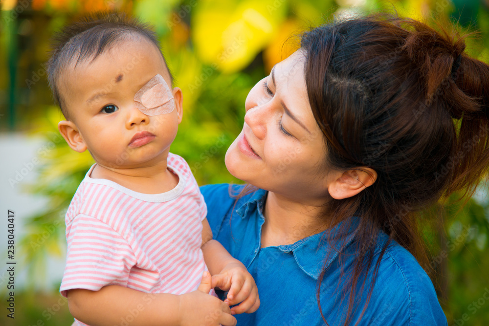 Asian female model and asian baby pose for pictures in the nature Asian female model and asian baby pose for pictures in the nature