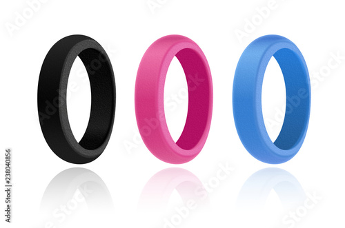 3D style mock-up illustration of silicone rings of three colours: black, pink and blue. Realistic plastic texture. White background and glance shadow underneath  photo