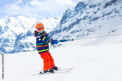 Child on ski lift. Kids skiing.