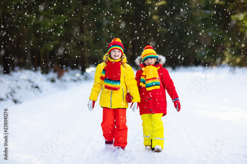 Kids winter snow ball fight. Children play in snow