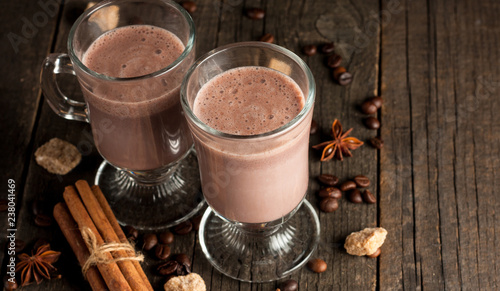 Chocolate, coffee, milk, banana shake on wooden background. Smoothie with cookies. Milkshake. Protein diet. Healthy food concept.