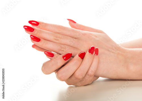 female hands with red manicure.