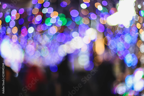 blurred christmas holidays background. Festive fair and colorful lights.
