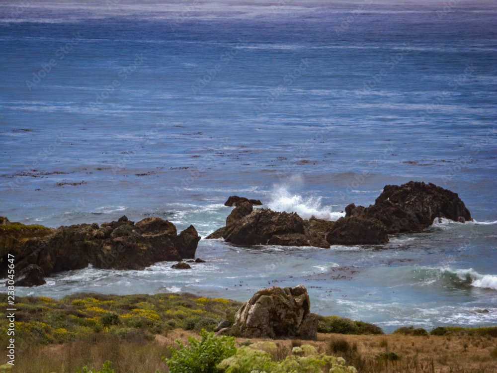 waves crash on rocks in Central Coast, California