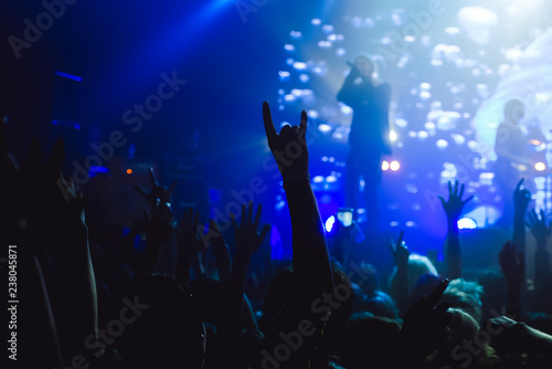 Hands of a crowd raised up at the music show to the singer on stage © kondrukhov