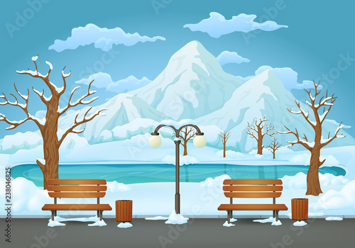 Winter day in the park, two benches with trash cans and street lamp with frozen lake and mountains in the background.
