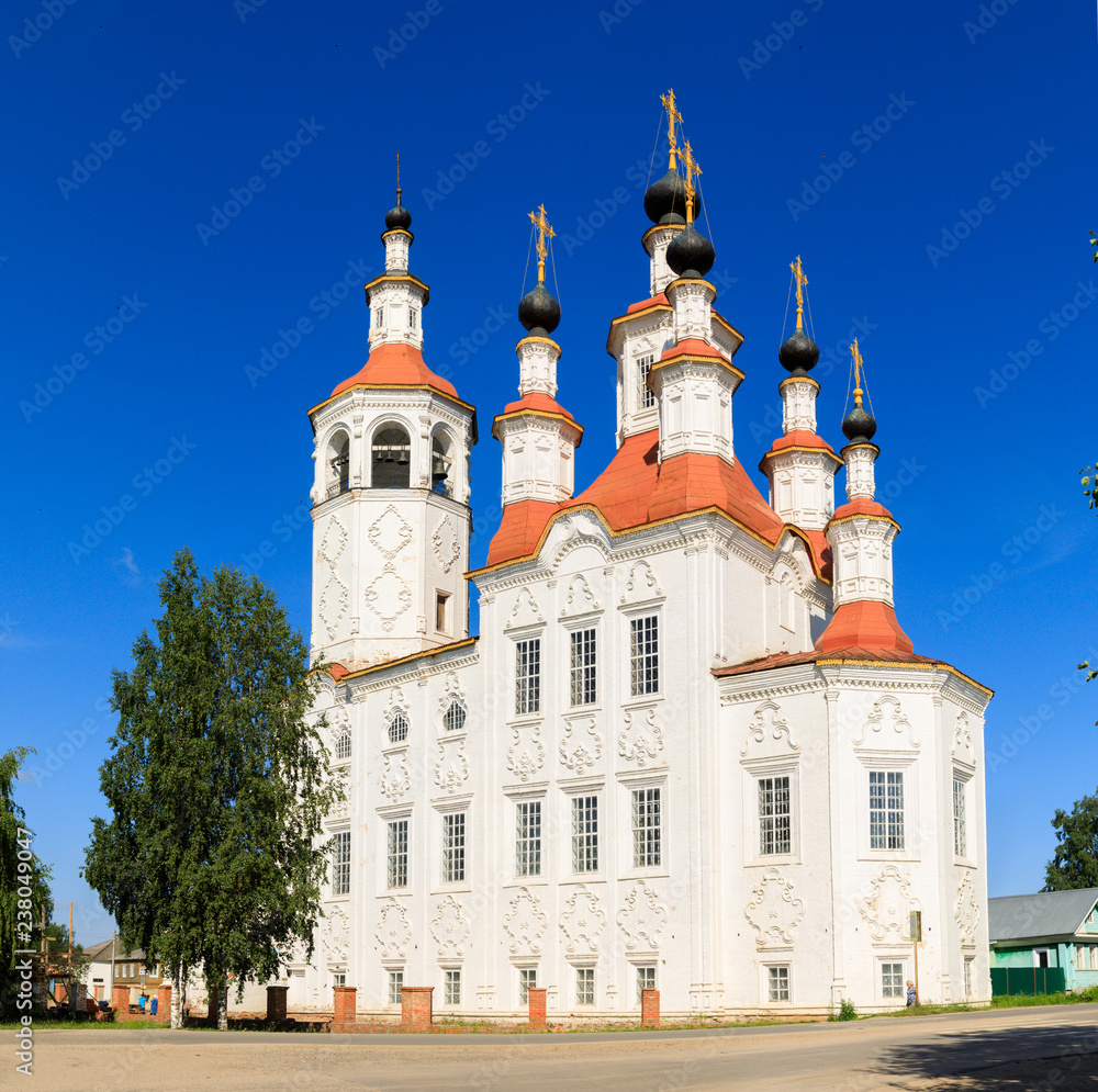 Russian white orthodox Temple of the Entry of the Lord into Jerusalem against the blue sky The Nativity Church, Totma, Russia. Architectural forms reminiscent of a ship.