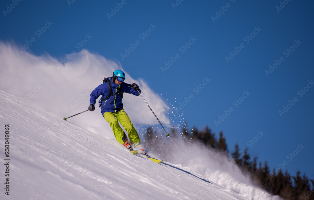 Skier having fun while running downhill