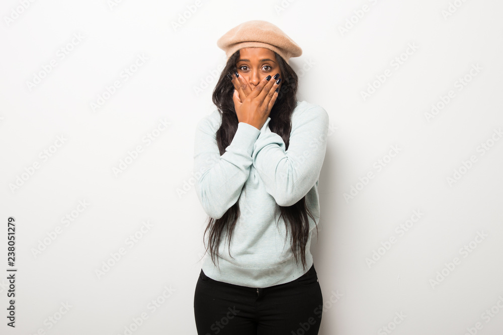 Young afro american woman on white wall covering mouth for saying something inappropriate. Can not speak Young afro american woman on white wall covering mouth for saying something inappropriate. Can not speak