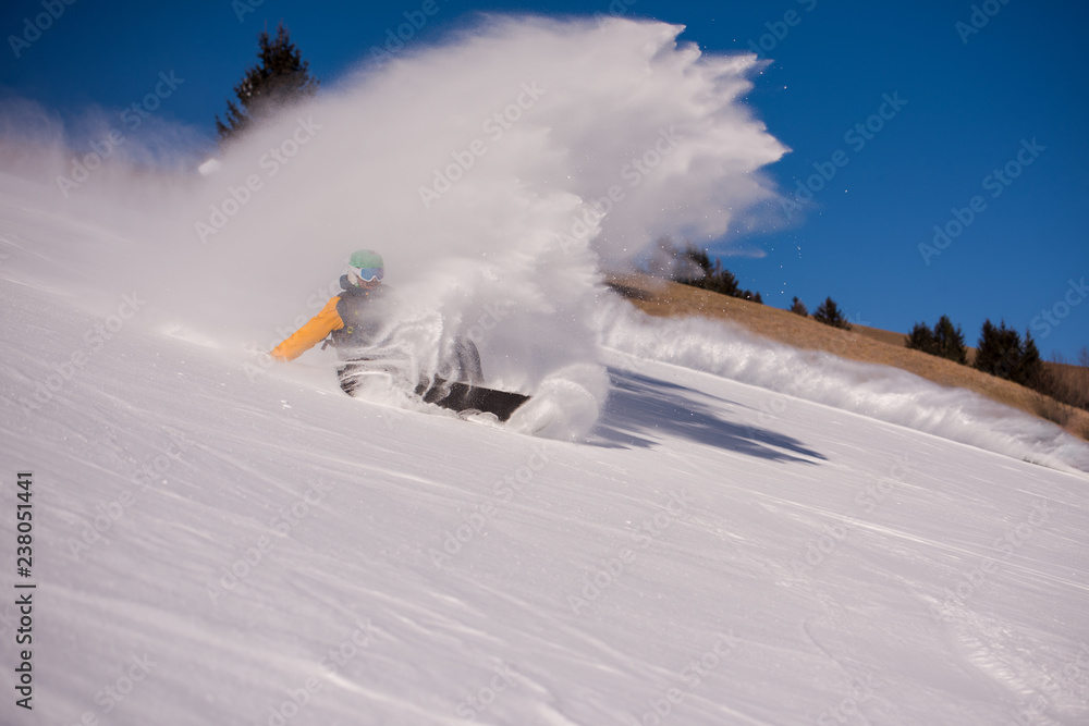 Fototapeta premium snowboarder crashes while carving down