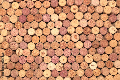 old wine corks from red wine among used wine corks from white wine and from sparkling wine as abstract brown cork background