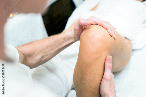 Massage Physical Therapist Checking Woman's Legs