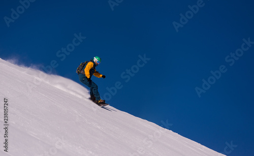 snowboarder running down the slope and ride free style