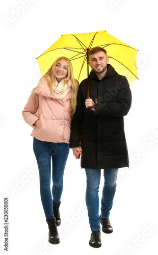 Full length portrait of beautiful couple with umbrella, isolated on white