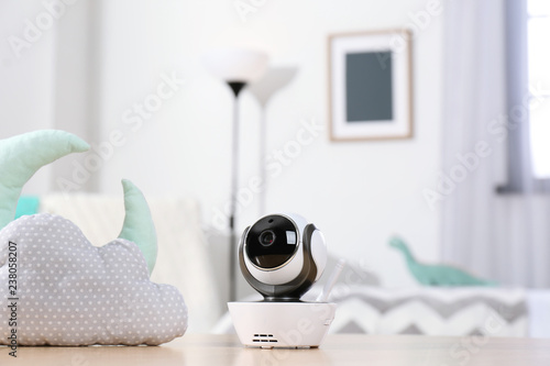 Baby monitor and toys on table in room. CCTV equipment