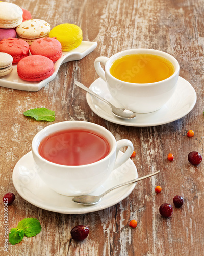 Fruit tea and macaroons on wooden background