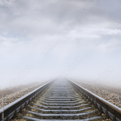 railroad in fog to horizon in clouds