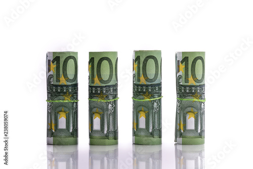фотографія Euro banknotes rolled up on a white background several hundred euros