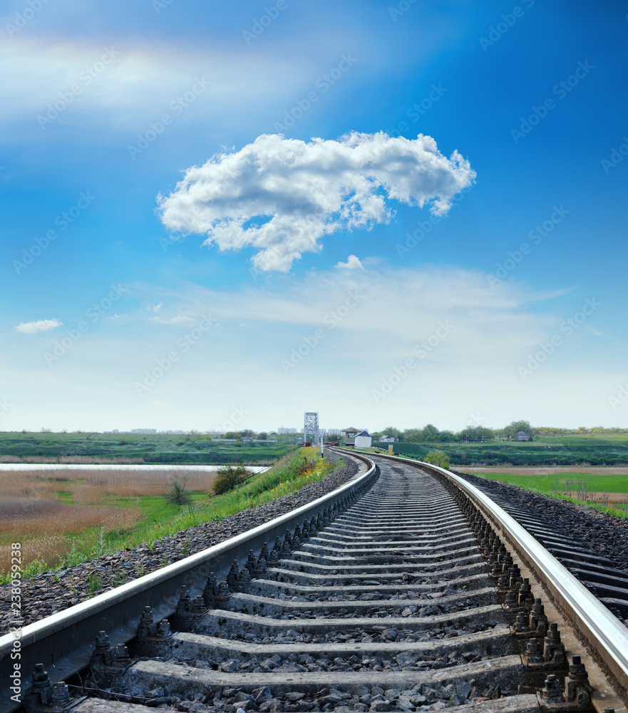 railway closeup to horizon and cloud in blue sky over it