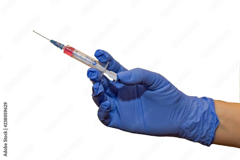 hands in rubber gloves with two syringes and cotton wool on a white background. Doctor in medical glove holding syringe on white background. hands in rubber gloves with two syringes and cotton wool on a white background. Doctor in medical glove holding syringe on white background.