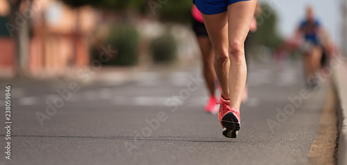 Marathon running in the light of evening  detail on legs