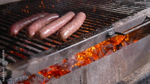 Cooking concept. Barbecue sausages grilled on a fire grill photo