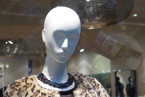 white mannequin's head with a dark blue neckless 
