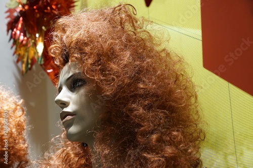 mannequin's head with long red curly hair and make-up