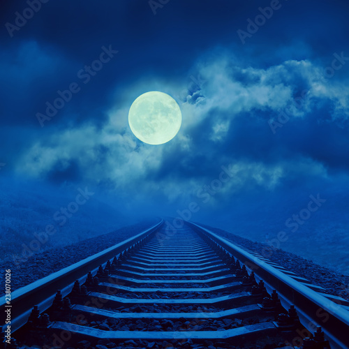 full moon in cloudy over night railroad
