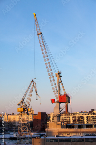 Construction cranes work in the port of Helsinki in winter