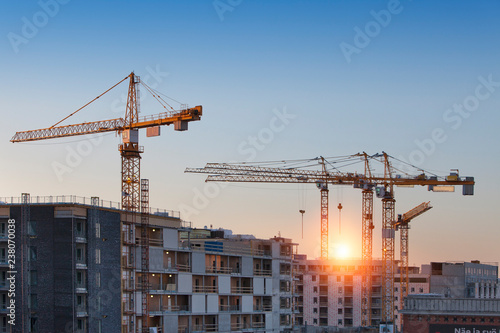 Construction cranes work in thef Helsinki in winter
