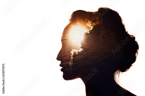 Multiple exposure portrait of a woman. The sun behind the clouds. Emotional intelligence concept. photo