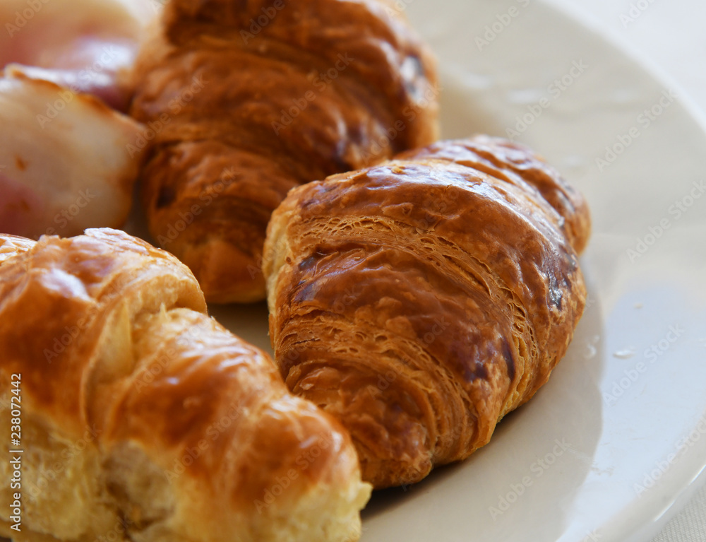 A Several delicious croissants on a plate
