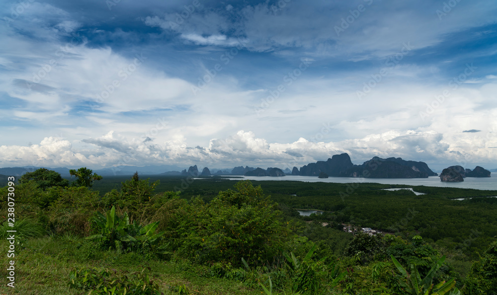 Green mountainous islands swim in the azure sea. View from the top of the island. Green mountainous islands swim in the azure sea. View from the top of the island.