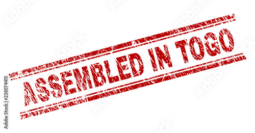 ASSEMBLED IN TOGO seal imprint with grunge texture. Red vector rubber print of ASSEMBLED IN TOGO text with corroded texture. Text caption is placed between double parallel lines.