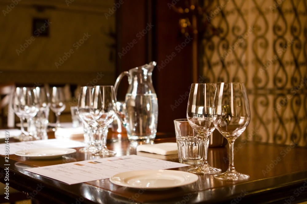 wineglasses and glass jugs on a table ready for wine testing in a restaurant wineglasses and glass jugs on a table ready for wine testing in a restaurant