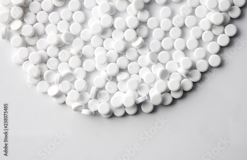 White pills isolated on white background, conceptual image