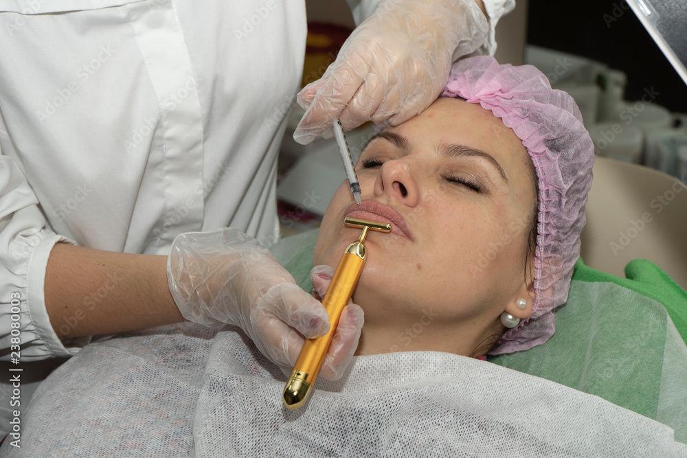 Cosmetic procedure for lip augmentation. The beautician does injection into the lips, for augmentation. Plastic surgery. Cosmetic procedure for lip augmentation. The beautician does injection into the lips, for augmentation. Plastic surgery.