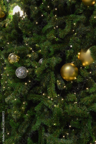 christmas tree in close-up look, full of decorations and lights, giving the atmosphere of magical christmas in december.