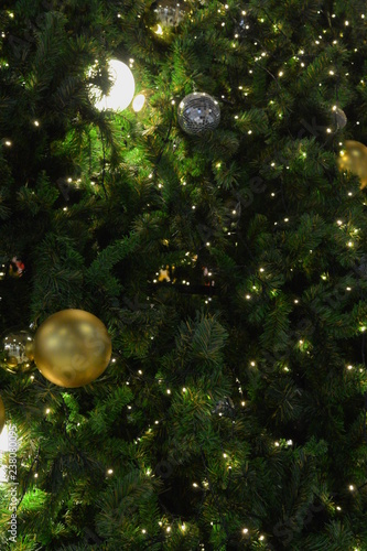 christmas tree in close-up look, full of decorations and lights, giving the atmosphere of magical christmas in december.