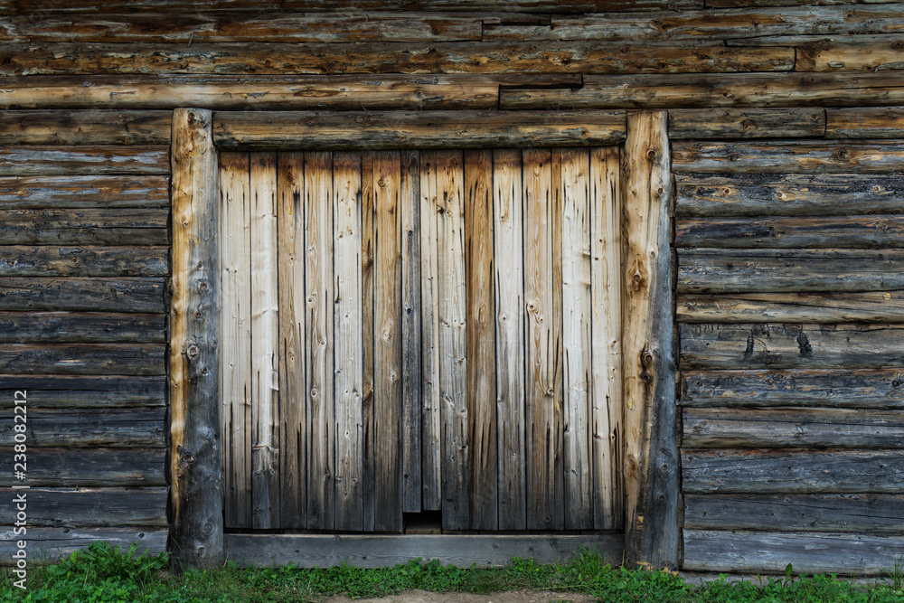 Abandoned barn vintage wooden door. Old photo of rustic house entrance