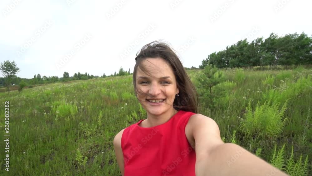 Beautiful woman taking selfie video using smartphone outdoors Girl sharing photograph on social media with mobile phone. Beautiful woman taking selfie video using smartphone outdoors Girl sharing photograph on social media with mobile phone.