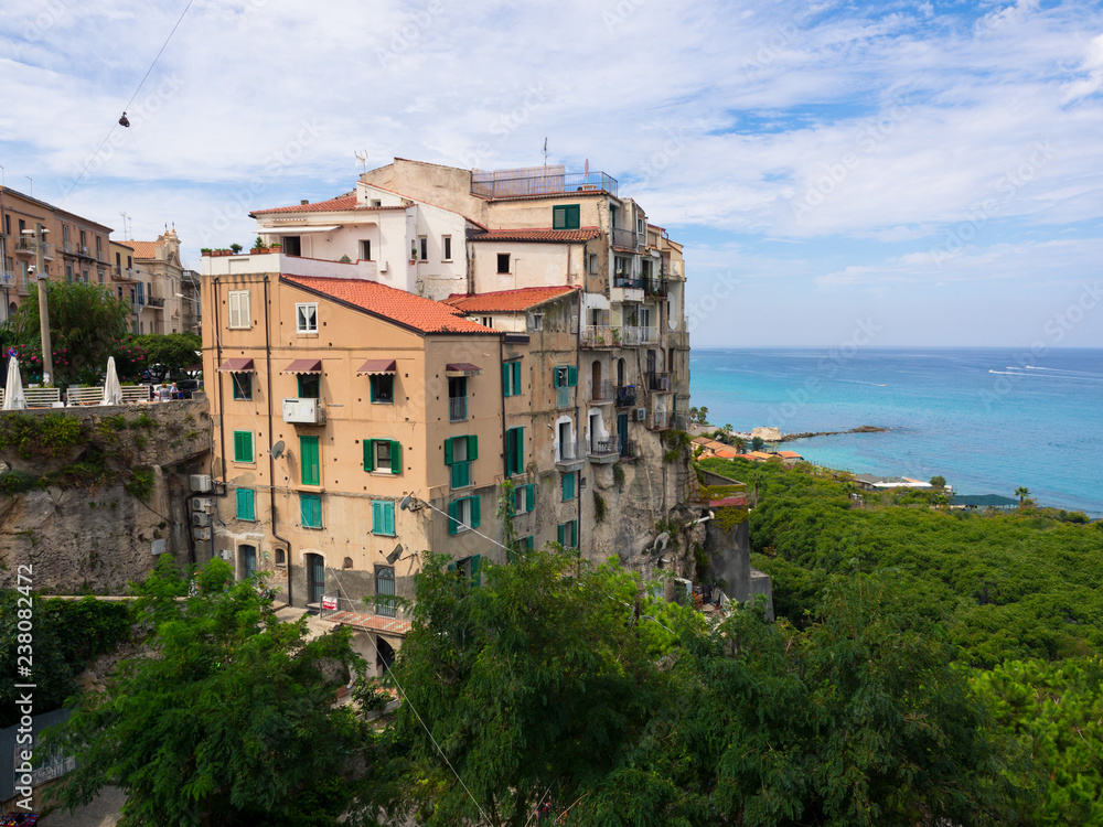 View of Tropea, a tourist resort in Italy perched on a cliff overlooking the sea.