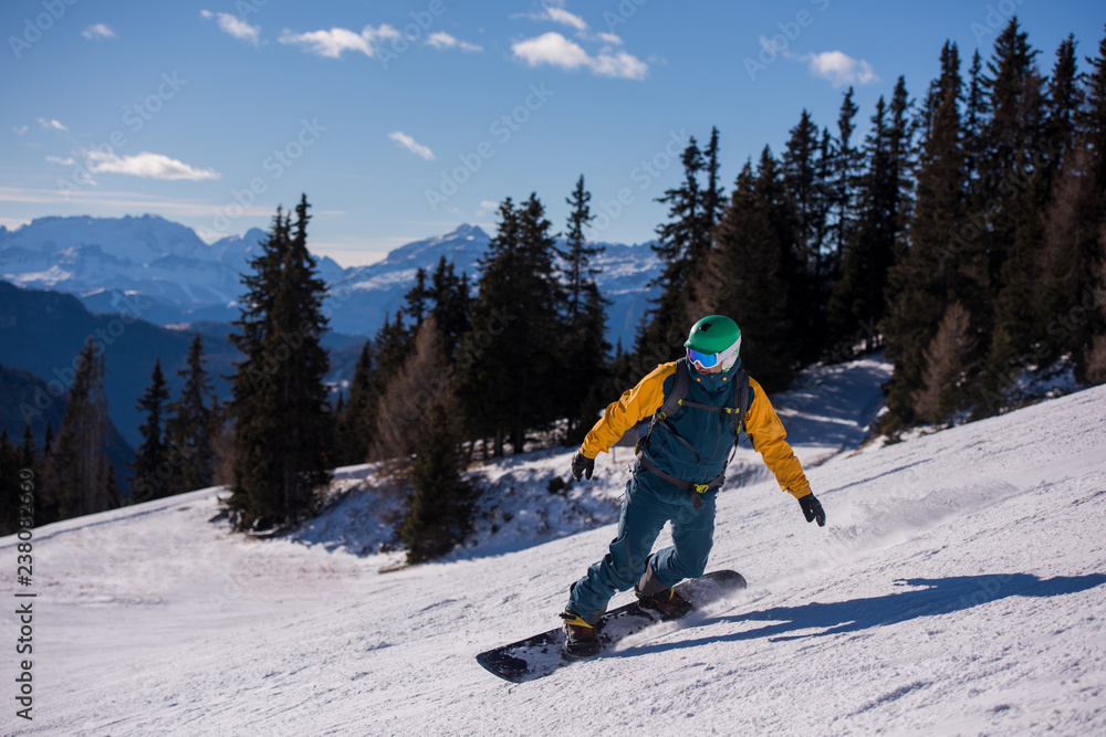 snowboarder running down the slope and ride free style snowboarder running down the slope and ride free style