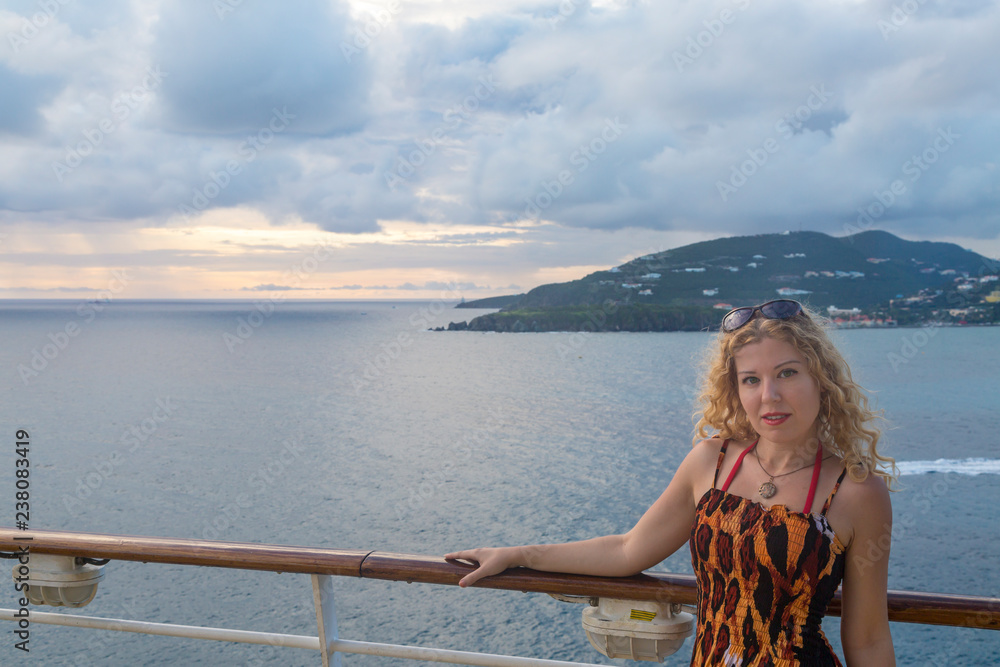 Blond woman on cruise ship with sunset view in Philipsburg, St Martin