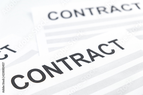The concept of successful contracts. The word "contract" is printed on paper.