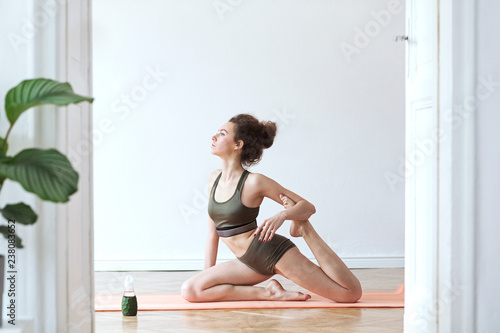Young woman doing yoga in open space